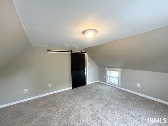 1023 W Franklin St, Evansville, IN 47710 - bonus room featuring vaulted ceiling, carpet floors, baseboards, and a barn door