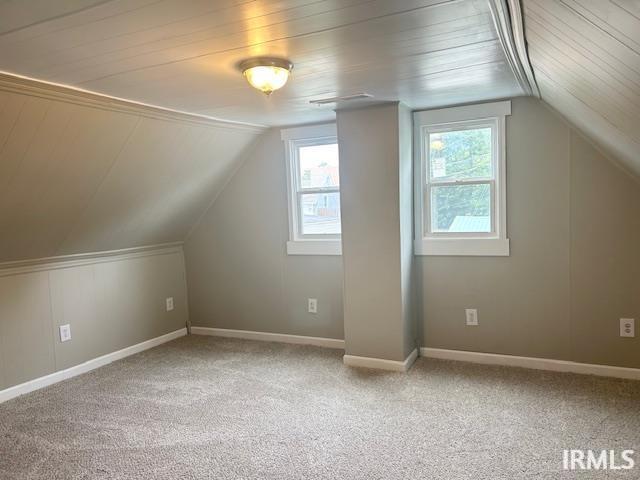 1023 W Franklin St, Evansville, IN 47710 - additional living space with carpet floors, vaulted ceiling, wooden ceiling, and baseboards