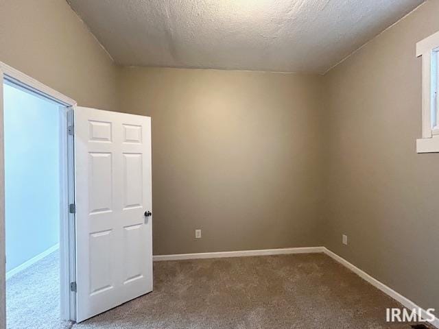1023 W Franklin St, Evansville, IN 47710 - spare room featuring carpet, a textured ceiling, and baseboards