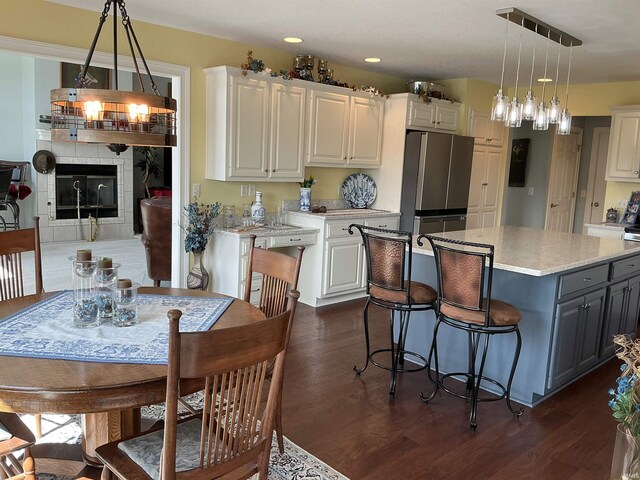 12217 Harvest Bay Dr, Fort Wayne, IN 46845 - kitchen featuring freestanding refrigerator, white cabinets, dark wood-style floors, and recessed lighting