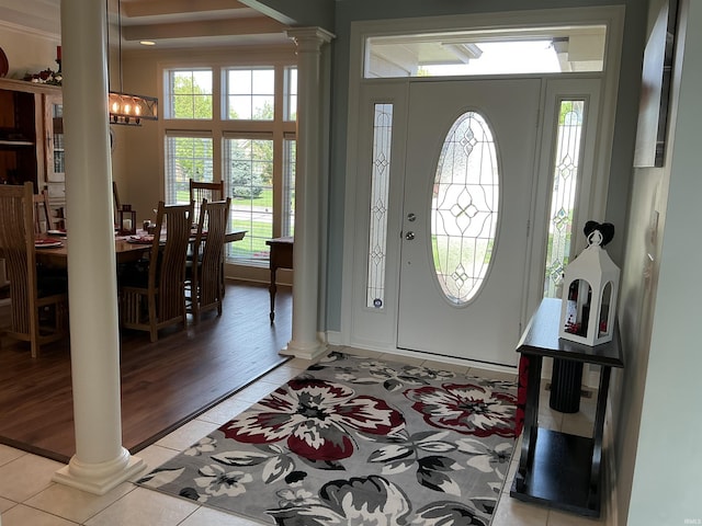 12217 Harvest Bay Dr, Fort Wayne, IN 46845 - entryway featuring ornate columns, light tile patterned floors, and a chandelier