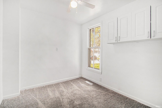 spare room with carpet flooring, baseboards, and a ceiling fan