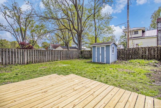 wooden deck featuring a storage shed and an outdoor structure
