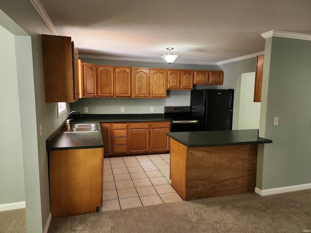 kitchen with freestanding refrigerator, dark countertops, ornamental molding, range with electric stovetop, and a sink