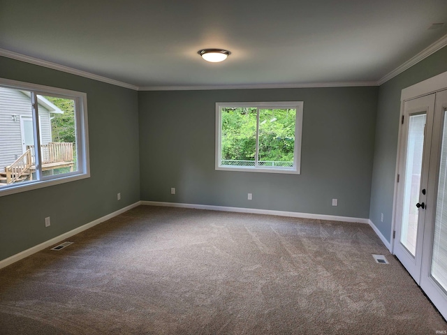 unfurnished room featuring carpet flooring, ornamental molding, and baseboards