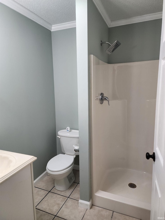 bathroom with a textured ceiling, a stall shower, tile patterned flooring, toilet, and ornamental molding