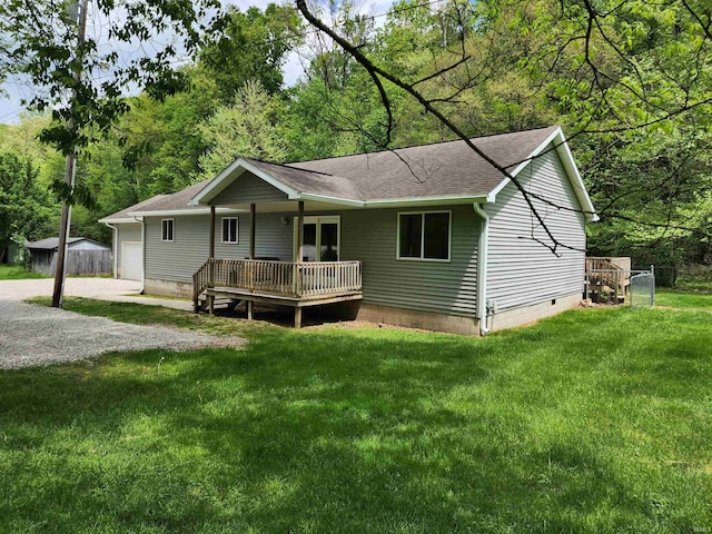 back of property with a shingled roof, crawl space, and driveway