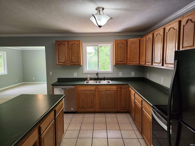 kitchen featuring black appliances, a sink, dark countertops, plenty of natural light, and a textured ceiling