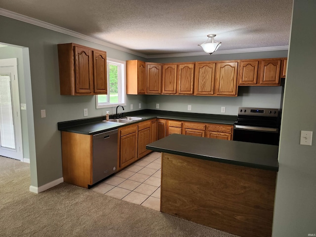 kitchen featuring appliances with stainless steel finishes, a sink, dark countertops, light carpet, and ornamental molding