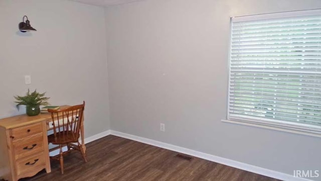 home office featuring dark wood-type flooring and baseboards