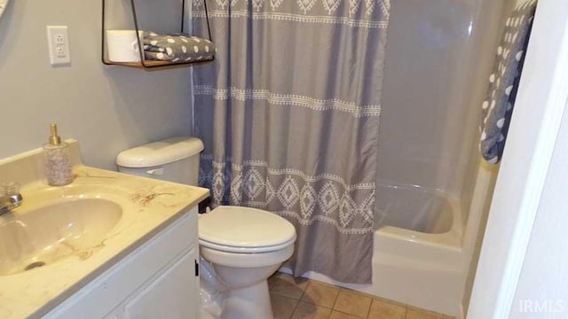 full bathroom featuring toilet, tile patterned flooring, vanity, and shower / tub combo with curtain