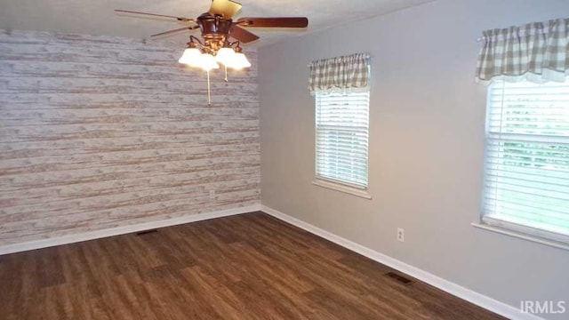 unfurnished dining area featuring baseboards, healthy amount of natural light, and wood finished floors