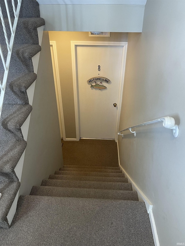 stairway with carpet flooring and baseboards