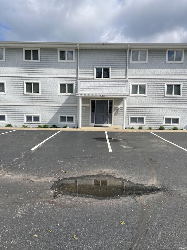 view of building exterior featuring uncovered parking