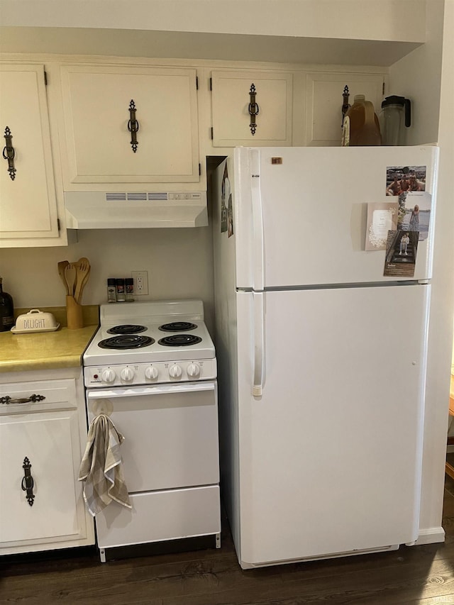 kitchen with white appliances, under cabinet range hood, dark wood finished floors, light countertops, and white cabinetry