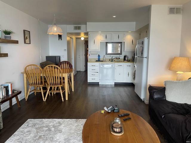 living area featuring dark wood finished floors and baseboards