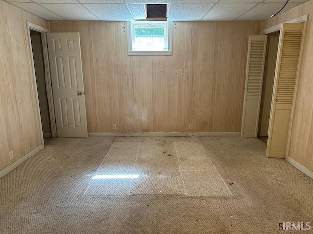 108 S Main St, Patoka, IN 47666 - basement with a drop ceiling, wooden walls, carpet, and baseboards