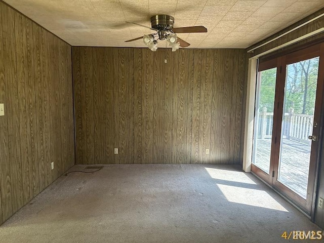 108 S Main St, Patoka, IN 47666 - carpeted spare room with wooden walls and ceiling fan