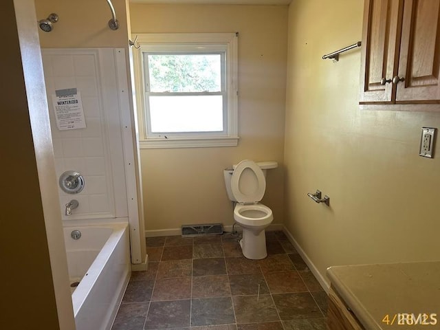 108 S Main St, Patoka, IN 47666 - bathroom with baseboards, toilet, washtub / shower combination, and stone finish floors
