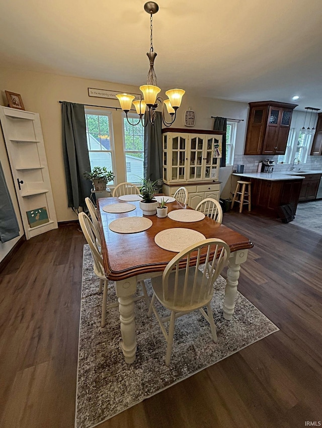 110 W Elnora St, Odon, IN 47562 - dining area featuring a chandelier, dark wood-style floors, and plenty of natural light