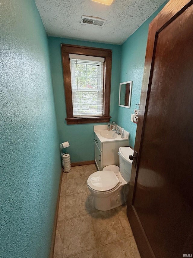110 W Elnora St, Odon, IN 47562 - half bathroom featuring toilet, a textured wall, a textured ceiling, tile patterned floors, and baseboards