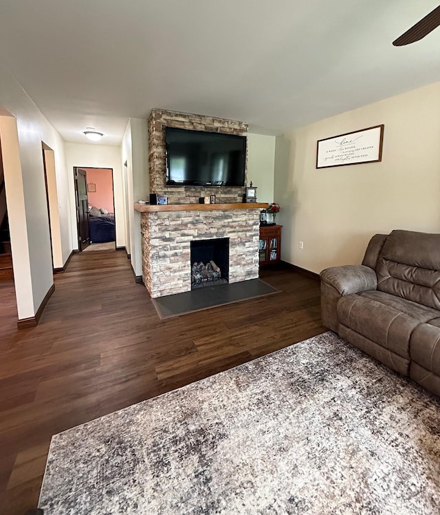 110 W Elnora St, Odon, IN 47562 - living room featuring ceiling fan, baseboards, wood finished floors, and a fireplace