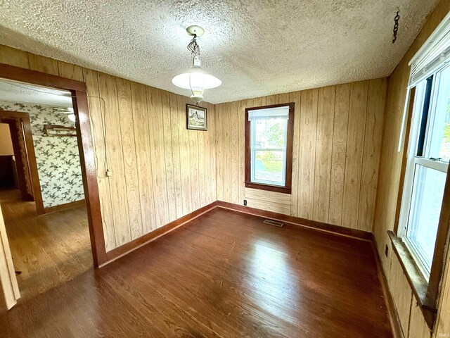 219 W Boone St, Gentryville, IN 47537 - unfurnished dining area with wood finished floors, a textured ceiling, and baseboards