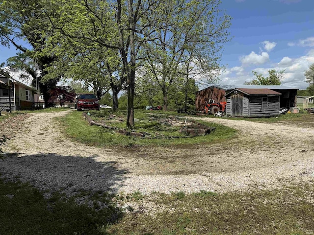 219 W Boone St, Gentryville, IN 47537 - view of yard featuring an outdoor structure and dirt driveway