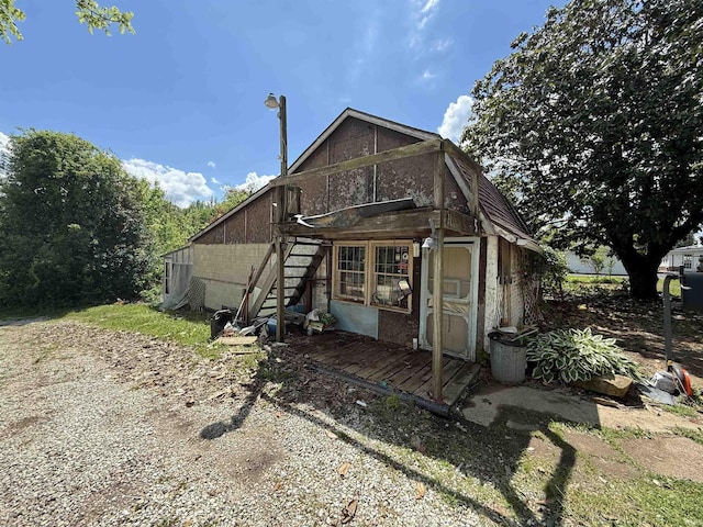 219 W Boone St, Gentryville, IN 47537 - rear view of property with concrete block siding, stairs, and an outbuilding