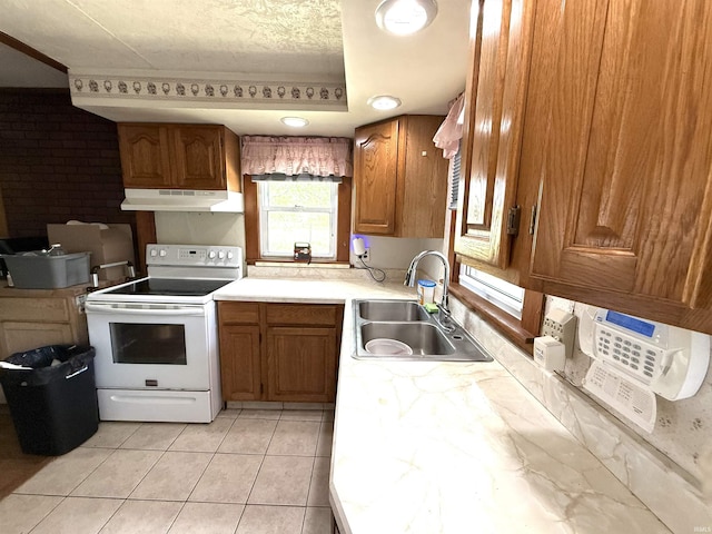 219 W Boone St, Gentryville, IN 47537 - kitchen featuring electric range, under cabinet range hood, a sink, brown cabinetry, and light countertops