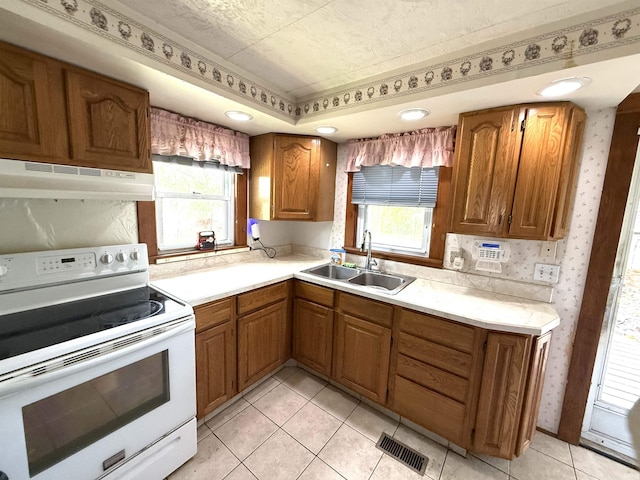 219 W Boone St, Gentryville, IN 47537 - kitchen featuring electric stove, a sink, under cabinet range hood, brown cabinets, and light countertops