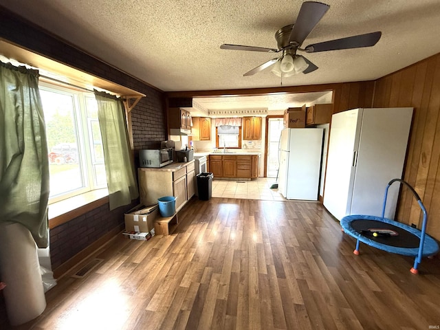 219 W Boone St, Gentryville, IN 47537 - kitchen featuring freestanding refrigerator, plenty of natural light, light countertops, a textured ceiling, and wood finished floors