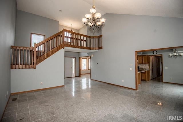 10217 Lake Tahoe Ct, Fort Wayne, IN 46804 - unfurnished living room featuring a chandelier, baseboards, high vaulted ceiling, granite tiled floors, and stairway