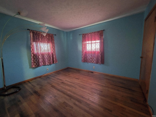 4980 W 200 N, Kokomo, IN 46901 - empty room with healthy amount of natural light, wood finished floors, a textured ceiling, and baseboards