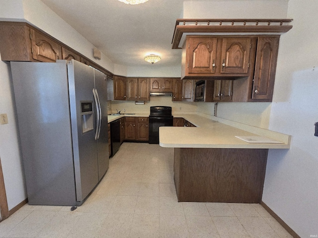 4980 W 200 N, Kokomo, IN 46901 - kitchen with black appliances, a peninsula, light countertops, baseboards, and under cabinet range hood