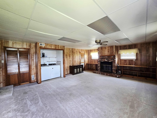 4980 W 200 N, Kokomo, IN 46901 - unfurnished living room with wood walls, a paneled ceiling, independent washer and dryer, ceiling fan, and a brick fireplace