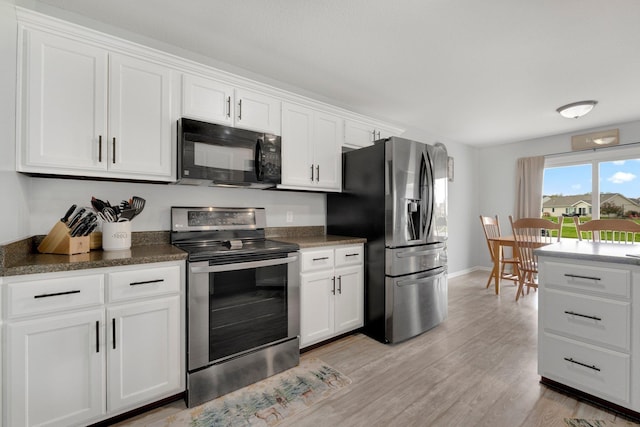 13726 Hamilton Meadows Ln, Fort Wayne, IN 46814 - kitchen with appliances with stainless steel finishes, light wood finished floors, white cabinets, dark countertops, and baseboards