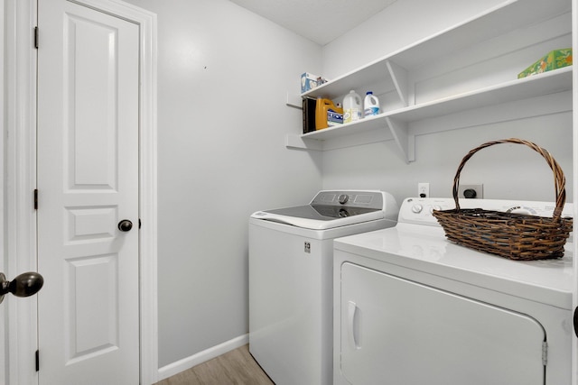 13726 Hamilton Meadows Ln, Fort Wayne, IN 46814 - laundry area featuring washer and clothes dryer, light wood finished floors, and baseboards