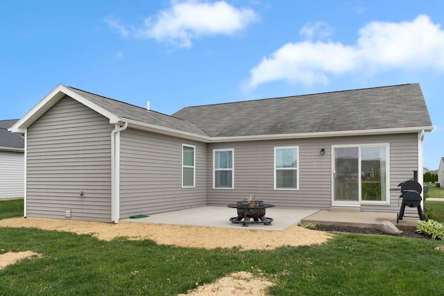 13726 Hamilton Meadows Ln, Fort Wayne, IN 46814 - back of property featuring a patio area, a yard, an outdoor fire pit, and roof with shingles