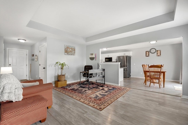 13726 Hamilton Meadows Ln, Fort Wayne, IN 46814 - living room with light wood-style flooring, baseboards, and a raised ceiling