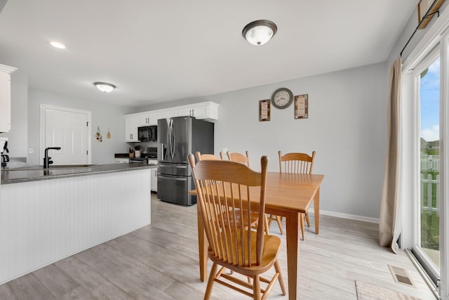 13726 Hamilton Meadows Ln, Fort Wayne, IN 46814 - dining room featuring plenty of natural light, light wood finished floors, and baseboards