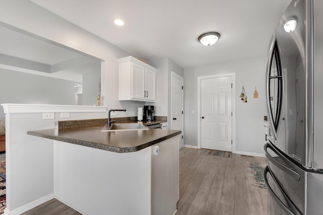 13726 Hamilton Meadows Ln, Fort Wayne, IN 46814 - kitchen featuring freestanding refrigerator, a sink, dark countertops, white cabinetry, and recessed lighting
