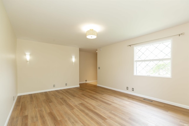 unfurnished room featuring light wood-style floors and baseboards