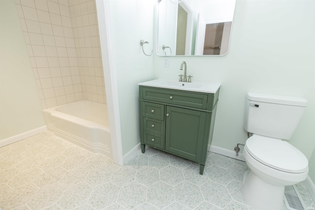 bathroom featuring baseboards, toilet, tile patterned floors, and vanity