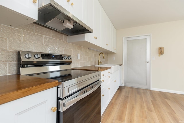 kitchen with electric range, range hood, a sink, light wood-type flooring, and white cabinetry
