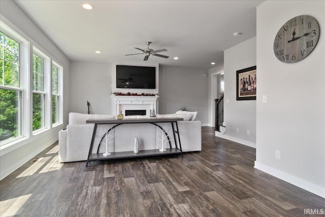 living area with a fireplace, ceiling fan, baseboards, dark wood-type flooring, and recessed lighting