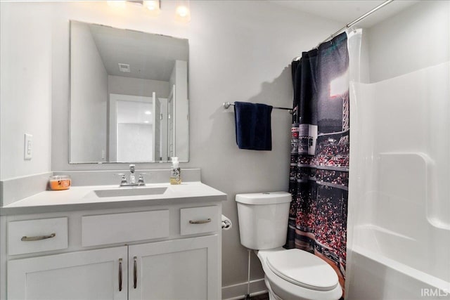 full bath with toilet, vanity, shower / bath combo with shower curtain, and baseboards