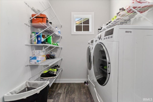 clothes washing area featuring separate washer and dryer, wood finished floors, and baseboards