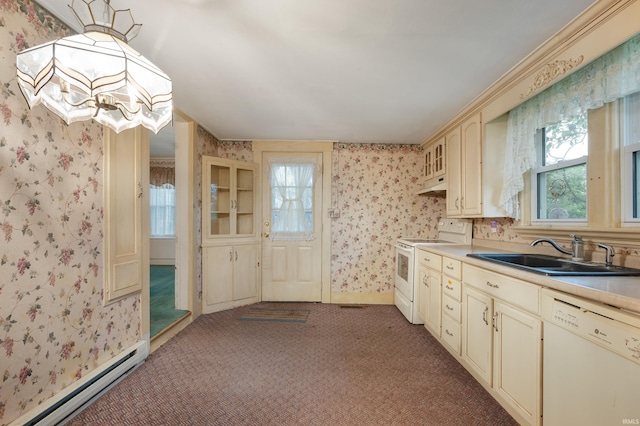 kitchen with white appliances, a sink, a baseboard heating unit, cream cabinetry, and wallpapered walls