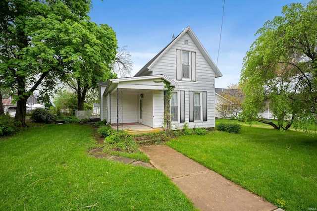 rear view of house with a porch and a lawn